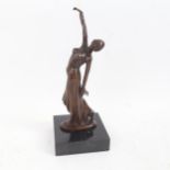 A reproduction bronze sculpture, Art Deco dancing lady, unsigned, on black marble plinth, overall