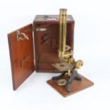 A brass student's microscope in mahogany case