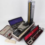 A blood pressure gauge, stethoscope, and 3 cased instruments