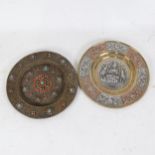 A Buddhist silver and copper overlaid brass roundel plaque, and an Eastern brass stone set dish,