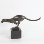 A reproduction modernist bronze running cheetah sculpture, unsigned, on black marble base, height
