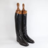 A pair of Vintage black leather horse riding boots, with wooden trees