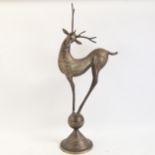 A large Middle Eastern engraved brass modernist stag sculpture, height 73cm