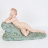 A painted figure of a reclining nude girl, length 44cm