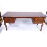 A 19th century fruitwood kneehole writing table, with 2 fitted drawers, raised on cabriole legs,