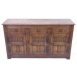 A 1920s oak sideboard with 3 carved frieze drawers, and 3 panelled doors, W153cm, H87cm, D46cm