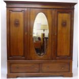 A 1920s oak triple wardrobe, having 1 mirrored door, and 2 drawers under, W198cm, H208cm, D55cm