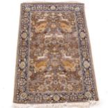 A brown ground Persian design rug, with symmetrical border and animal and bird decorated central