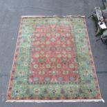 A red and green ground Persian design carpet, 350cm x 280cm Good overall condition, some wear in