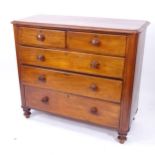 A Victorian chest of 2 short and 3 long drawers, with rounded corners and turned legs on bun feet,