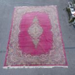 A red ground Persian design carpet, with floral embossed decoration, 370cm x 274cm Carpet has some