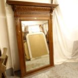 A large over mantel mirror, with carved oak frame and lion decoration, W120cm, H168cm