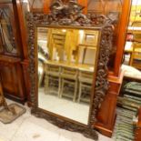 A large oak Black Forest wall mirror, with carved and pierced acanthus leaf decorations,