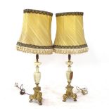 A pair of Art Deco brass and onyx table lamps, with shades, height overall 93cm