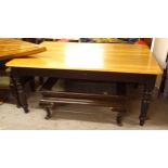 A large polished and painted pine kitchen table, on baluster turned legs