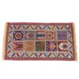 A small red ground Bakhtiari rug, 140cm x 73cm