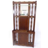 A 1920s panelled oak mirror-back hallstand, W93cm, H188cm