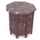 An Anglo-Indian octagonal table on folding stand, allover relief carved and pierced decoration,