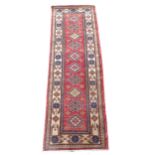 A small red ground Afghan design runner, 195cm x 66cm