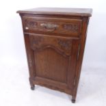 A Continental oak side cabinet, with single carved frieze drawer and cupboard under, W66cm,