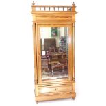 A French pitch pine armoire, with fitted shelves and single bevel-glazed door, with drawer under,