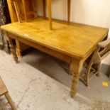 A rectangular pine farmhouse kitchen table, on turned baluster legs, L152cm, H78cm, D90cm