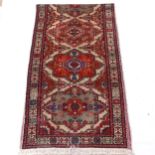 A cream ground Afghan runner, with symmetrical border and gold lozenge, 316cm x 86cm