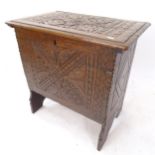 An Antique oak coffer of small size, with chipped carved decoration, W62cm, H62cm, D40cm