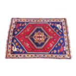 A red ground Persian rug, 155cm x 111cm