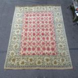 A cream ground Persian design carpet, with gold and red symmetrical floral pattern, 360cm x 270cm