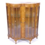 A 1920s walnut veneer double dome-front display cabinet, with 2 glass shelves, and keys, W100cm,