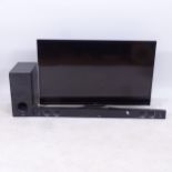 A JVC television, with remote, and an LG sound bar, GWO