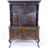 An Antique oak 2-section dresser, with 3 carved panelled drawers, on cabriole legs, (with keys)