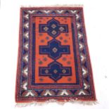 An orange ground Persian design rug, 174cm x 115cm