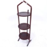 An Edwardian mahogany and satinwood-strung 3-tier folding cake stand