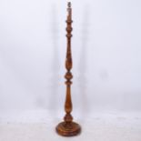 A stained beech baluster turned standard lamp, height to top of bayonet fitting 150cm