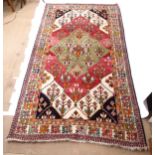 A red ground Turkish design carpet, with symmetrical border and triangular floral lozenge, 292cm x