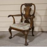 A fine 18th century walnut elbow chair in the manner of Giles Grendey, with relief carved urn-shaped