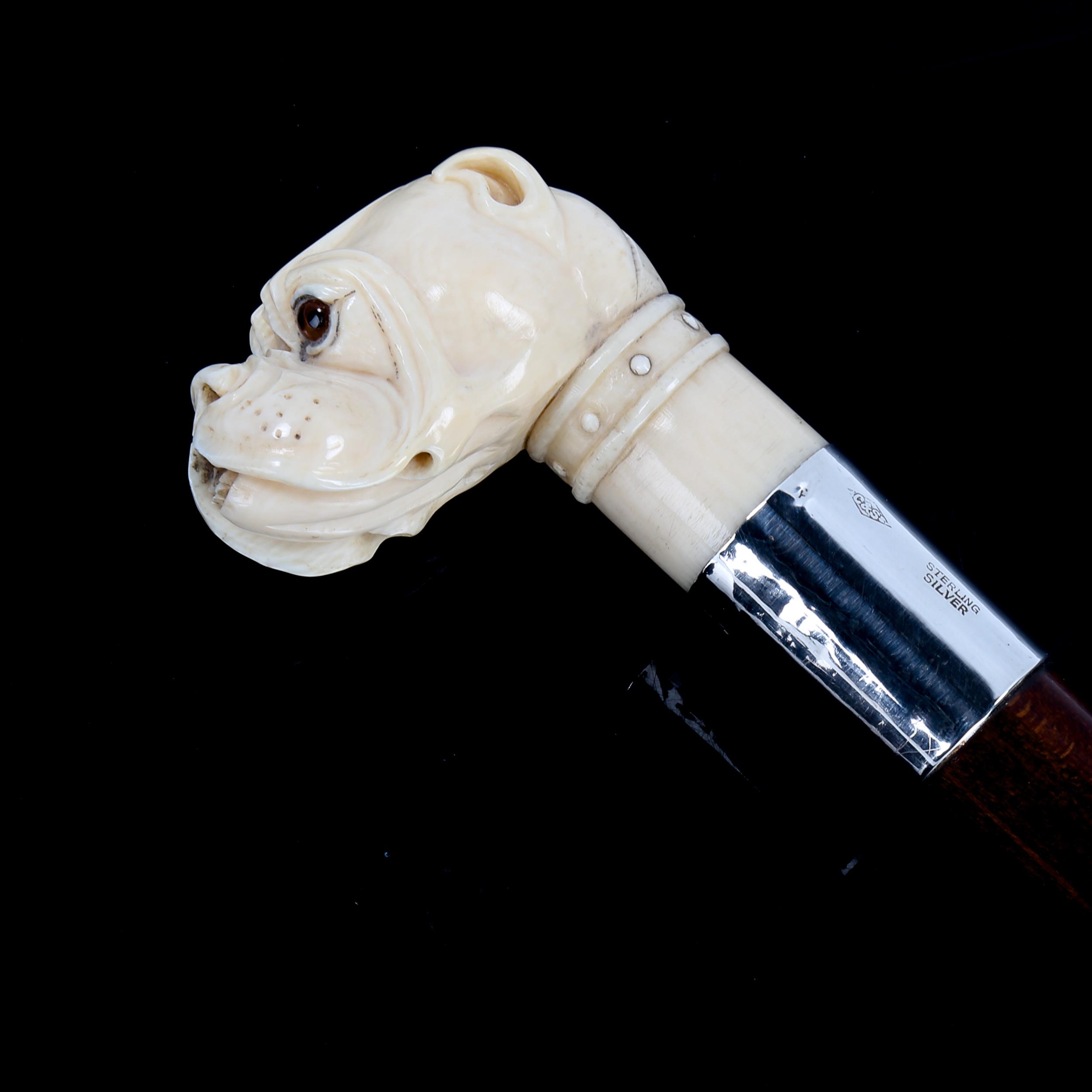 A 19th century carved ivory Bulldog-head handled walking cane with glass eyes, and sterling silver