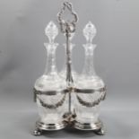 A 19th century electroplate 3-bottle decanter stand, with cast birds and floral swags, containing