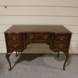 A walnut kneehole writing desk with frieze drawers and cabriole legs, early 20th century, width