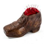 A 19th century Black Forest treen shoe design pin cushion, length 11cm