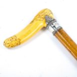 A 19th century French carved ivory-handled walking cane, with unmarked silver collar with coronet