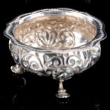 A George III silver bowl, relief embossed foliate decoration with beaded scalloped rim, by George