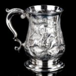 A George II silver pint mug, baluster form with relief embossed stag hunting scene and scrolled