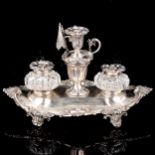 A Victorian silver desk ink stand, oval form with cast foliate rim, scrolled feet and silver-mounted