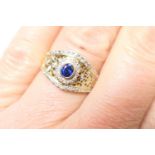 Sapphire and diamond cocktail ring, in 14ct gold, the central oval sapphire bordered with tiny round