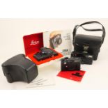 Leica CL camera body, no. 1316394, within a black leather carrying case; also a Leica C2-Zoom; and a
