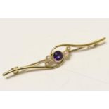 Edwardian amethyst and pearl bar brooch, in 15ct gold, the central round amethyst in a beaded collet