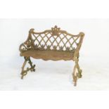 Cast iron garden seat, in Victorian style, having a lattice back and honeycomb seat raised on scroll